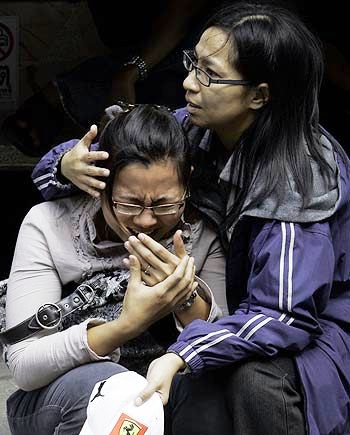 OVER 60 DEAD IN BANGKOK CLUB INFERNO A THAI WOMAN DISCOVERS THAT A LOVED ONE IS AMONG THOSE WHO DIED (PHOTO BY AP)